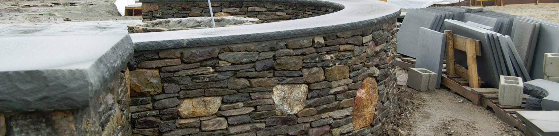 Site construction and natural stone wall work in progress